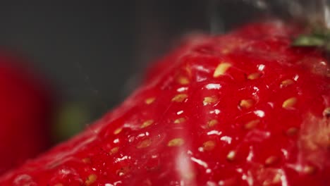 super close up water droplets splash onto red