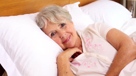 senior woman waking up in her bed