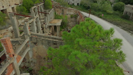 Laveria-Brassey,-Sardinia:-flying-over-the-ruins-of-the-buildings-of-this-old-abandoned-mine-on-the-island-of-Sardinia