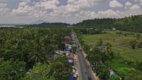 Ibbagamuwa-Sri-Lanka-Aerial-v1-drone-flyover-Kurunegala-above-Dambulla-road-capturing-village-town,-lush-jungle-greenery-and-agricultural-landscape-along-the-way---Shot-with-Mavic-3-Cine---April-2023