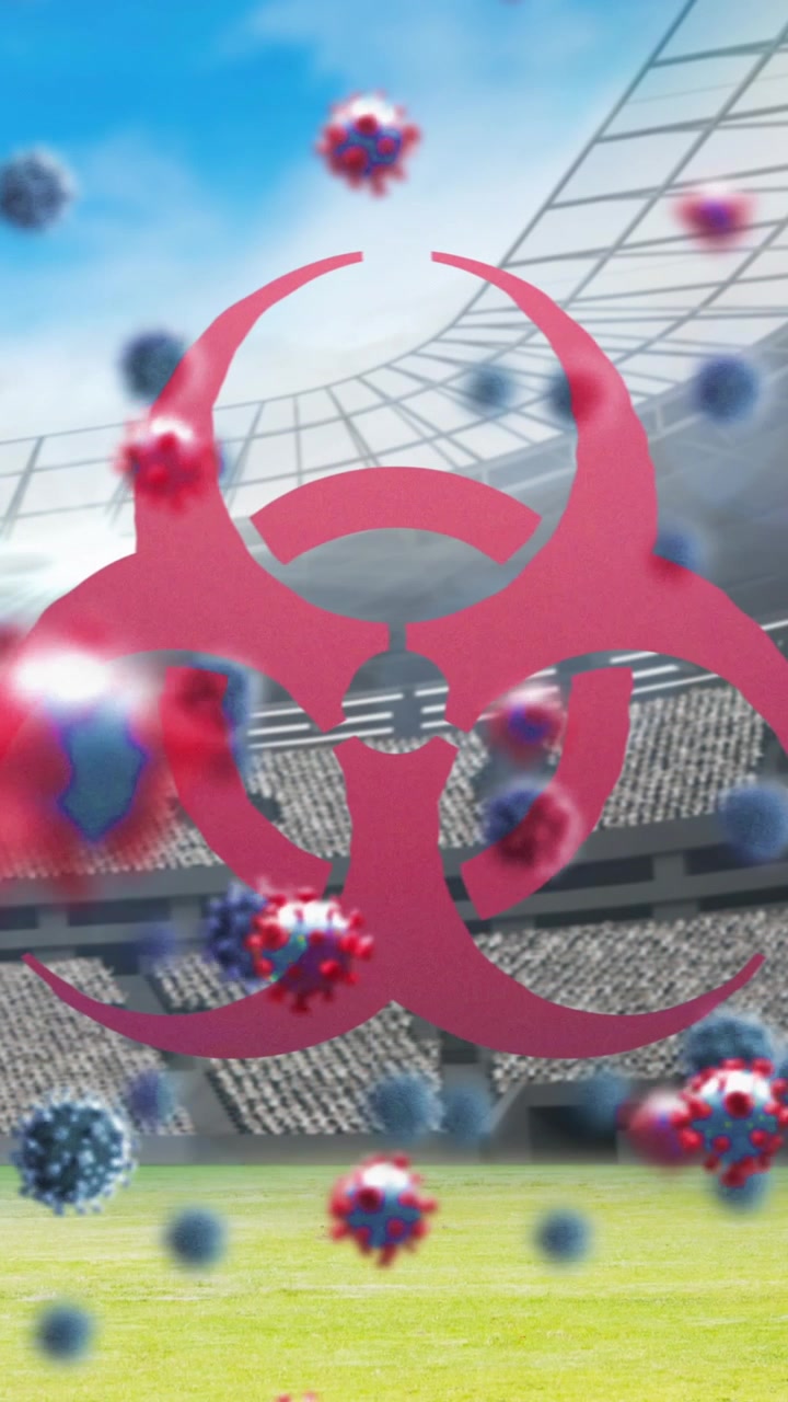 Bio hazard symbol and Covid-19 cells against empty sports stadium