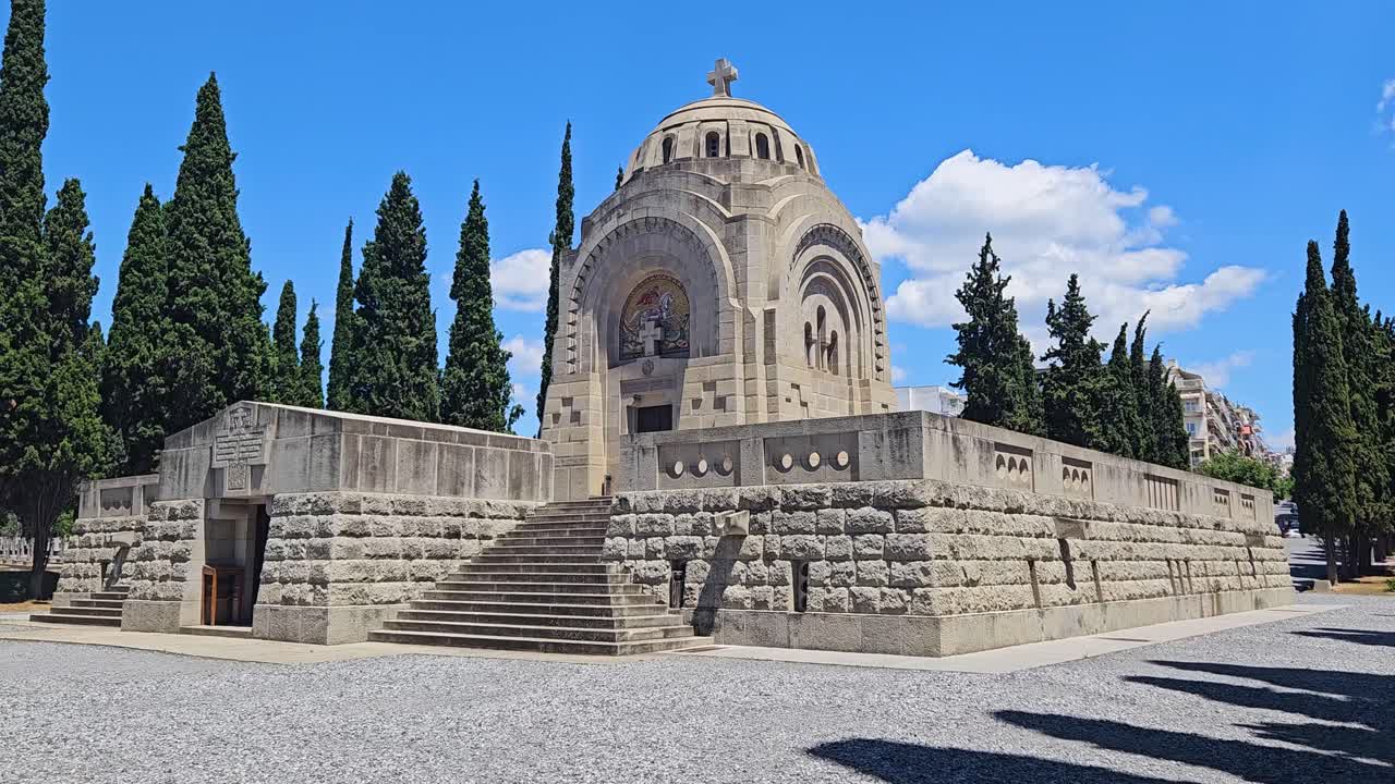 Central domed chapel at Zeitenlik Serbian Military Cemetery in Thessaloniki, Greece, surrounded by cypress trees, built to honor Serbian soldiers who died during World War I