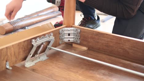 man assembling a bed frame