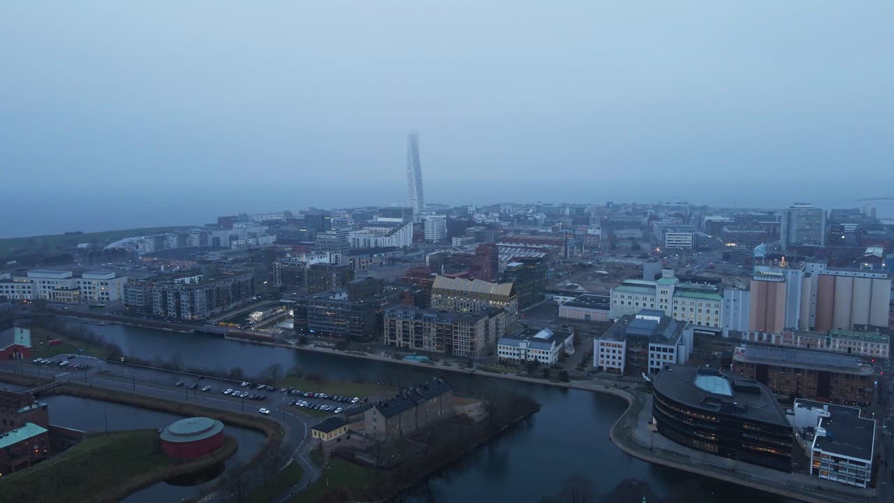 Jib down of the beautiful city of Malmö, Sweden on a fog covered morning. The historical High Court building is revealed while the drone descends