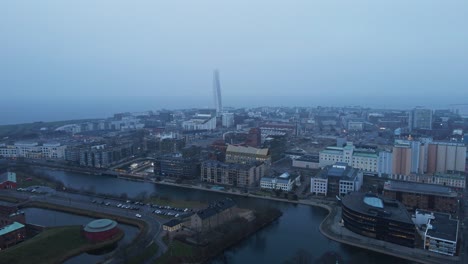 jib down of the beautiful city of malmö, sweden on a fog covered morning. the historical high court building is revealed while the drone descends