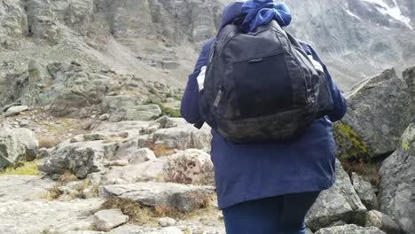 muslim woman hikes rocky mountains and finds glacial lake