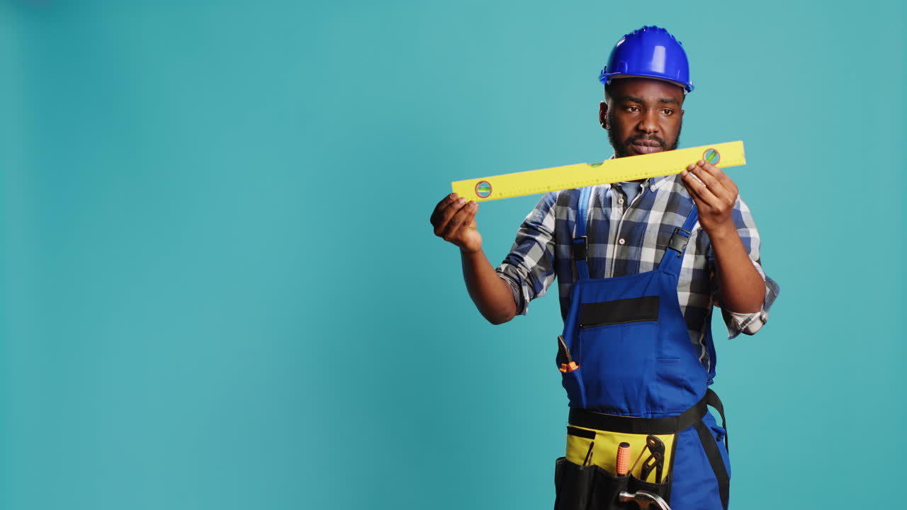 Repairman checking even surface with water level tool