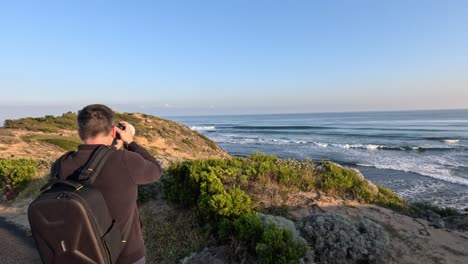 person photographing coastal scenery in melbourne, australia