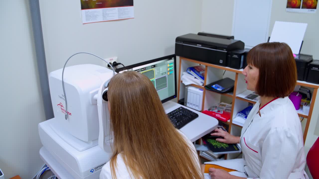 Checking vision of young woman. Optometrist examining patient in modern ophthalmology clinic