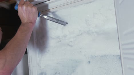 chiseling ice from a completely blocked freezer