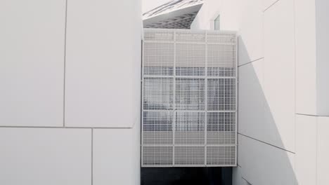 modern architecture detail with white facade and metal grid