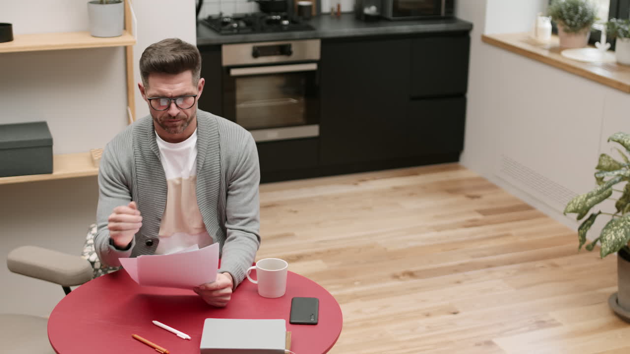 Man Looking Through Documents at Home