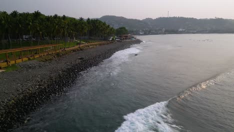 el salvador beach zooming drone shot of crashing waves at punta roca venue in la libertad, place where world class surf competitions are held - dolly in
