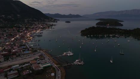 aerial orbits over nydri greece harbour at dusk, ionian sea coast