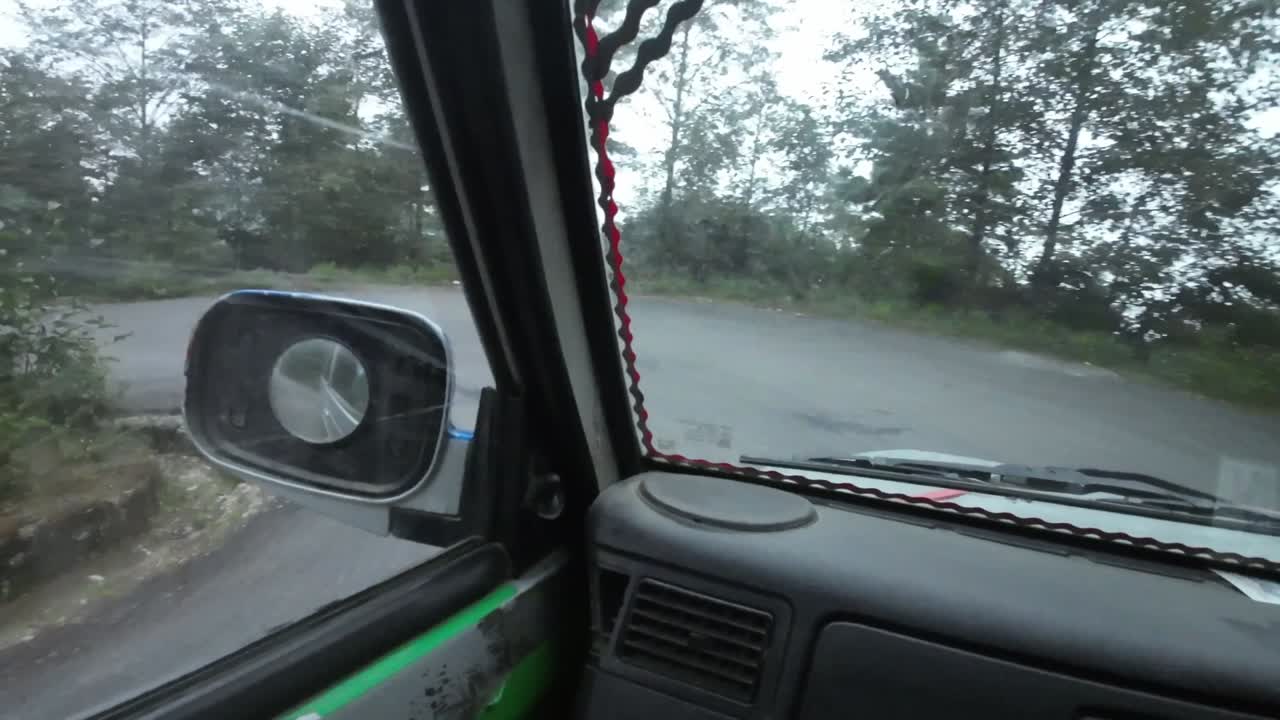 POV jeep ride through Nepal's rugged interior. Making a left turn on a windy mountain road