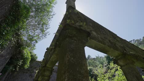 moss covered stone archway at convento de são francisco do monte, bathed in sunlight. viana do castelo, portugal