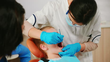 close up of girl patient lying on stomatological chair with open mouth