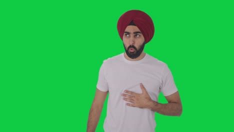 sick sikh indian man having an asthma attack green screen