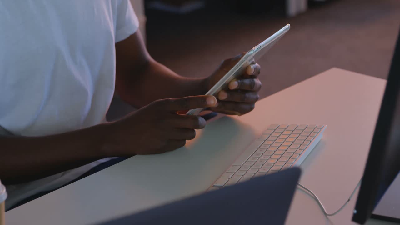 Mid section of male executive working on digital tablet at desk in modern office 4k