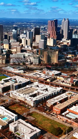 breath-taking view of atlanta panorama from aerial perspective. light blue sky with many white clouds above. top view. vertical video