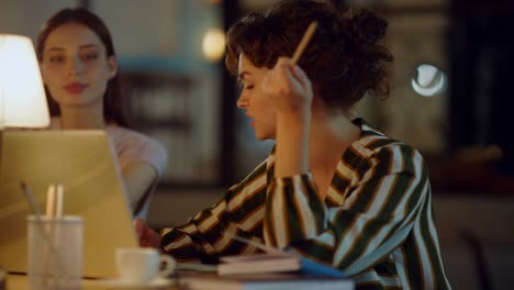 business lady talking colleague in office. woman pointing pencil laptop screen
