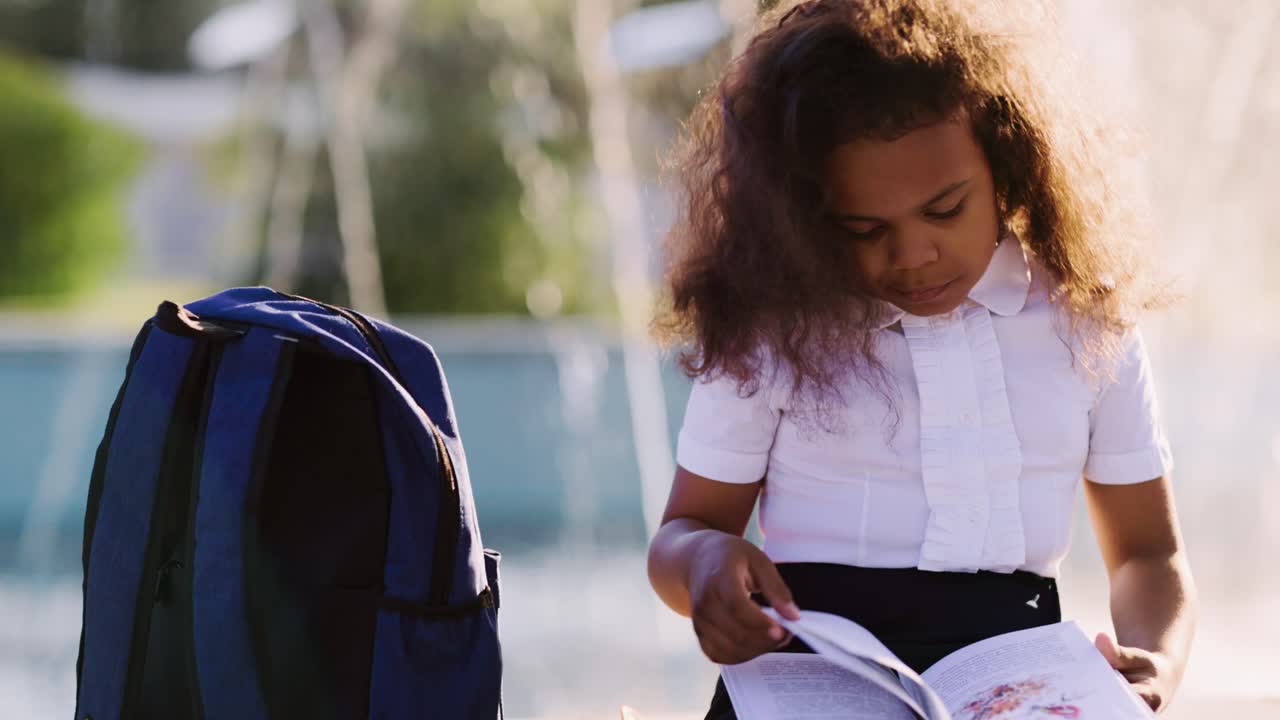Girl Reading a Book Outdoors