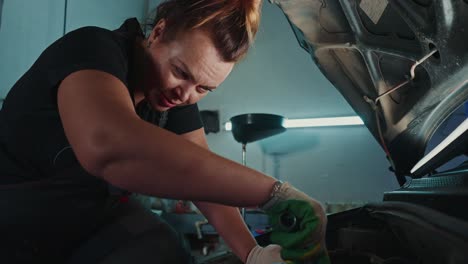 woman mechanic working on a car in a garage