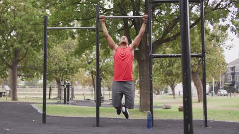 front view man with prosthetic leg doing pull ups