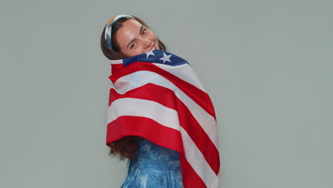 Lovely-young-woman-waving-and-wrapping-in-American-USA-flag,-celebrating,-human-rights-and-freedoms