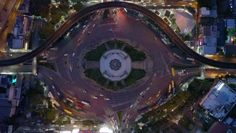 aerial view of huge roundabout and traffic lights at victory monument at night in bangkok, thailand