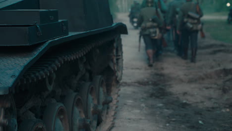 wwii tank and soldiers on the road