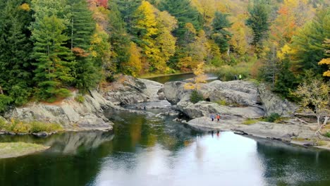 people at dog head falls in johnson vermont in the fall during foliage via 4k drone footage