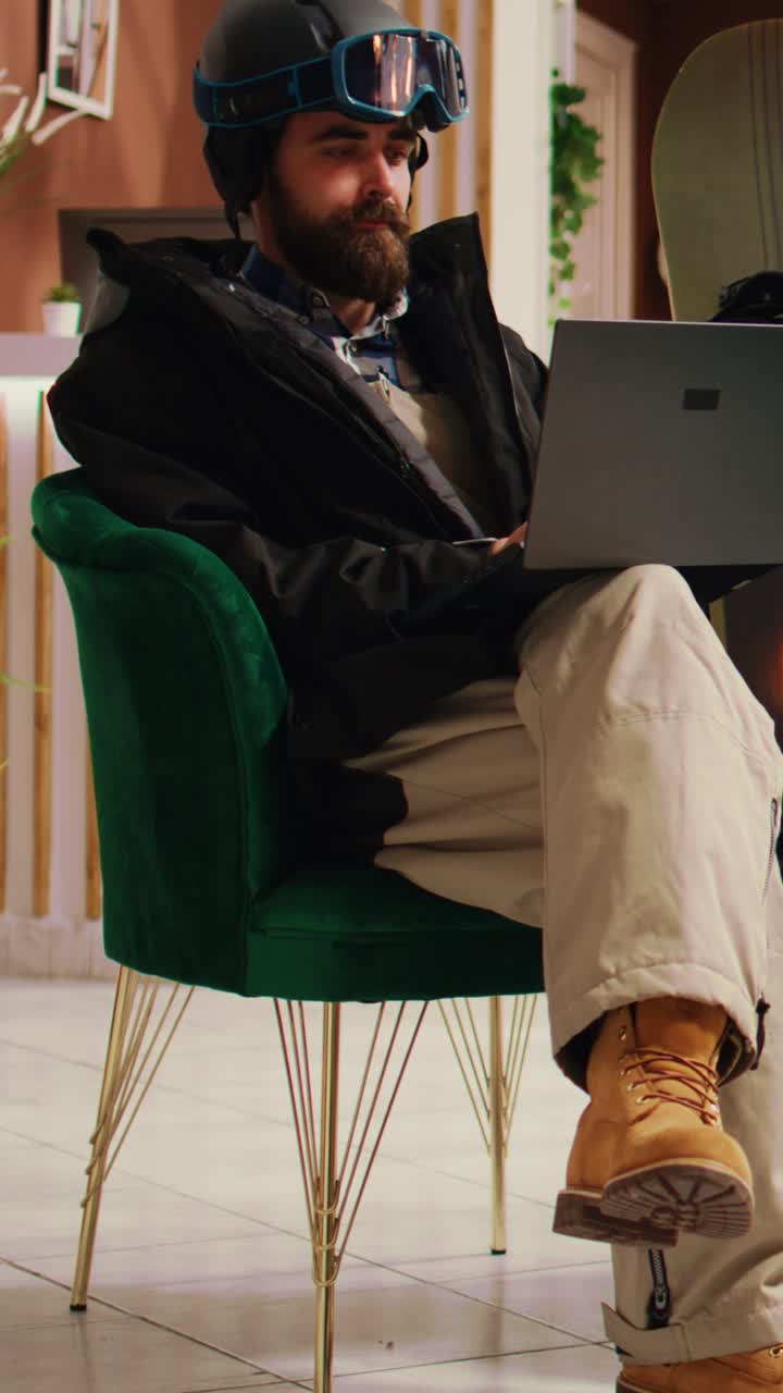 Vertical Video Young adult checks website on laptop