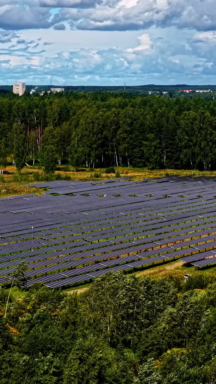Aerial orbiting vertical video of huge solar panel field setup in Latvia, Europe. Apt for renewable energy concept reels and shorts videos for mobile