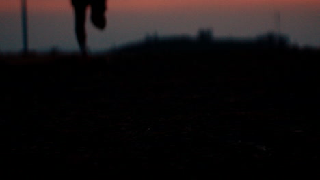 silhouette of a person running/walking at sunset/sunrise