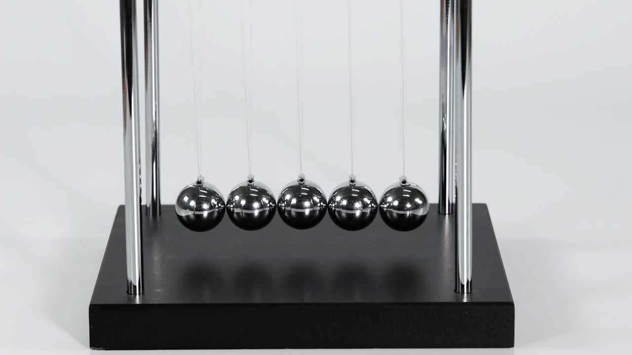 Detailed view of metal balls in motion, illustrating kinetic interactions and energy transfer.