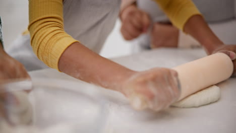 women, child and hands rolling dough in kitchen