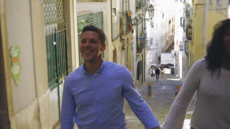 Joyful-multiracial-couple-happily-strolling-outdoor.