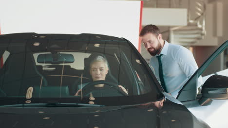 woman and salesman at car dealership