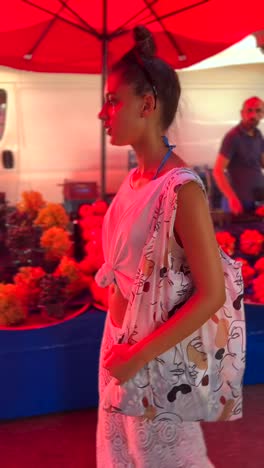 woman shopping at a vibrant outdoor market