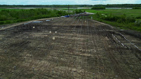 Aerial-drone-rising-shot-of-a-farmland-soil-being-prepared-for-seeding