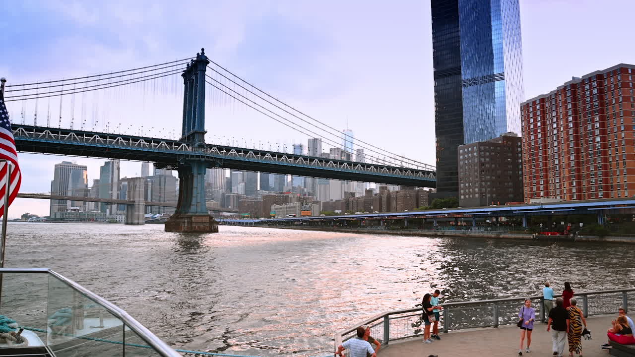 Footage from the boat front with American flag. View on the Manhattan Bridge and New York skyline at backdrop