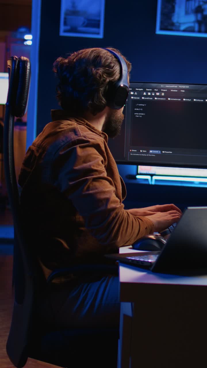 Bearded Man Coding Late Night on Computer in Dark Office