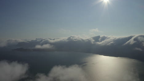 flying over cloud layer, lofoten, northern norway