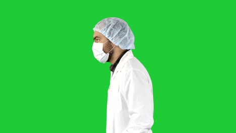 el doctor guapo con su uniforme y con una máscara está caminando en una pantalla verde, clave de croma
