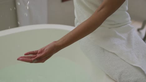 mixed race woman running a bath