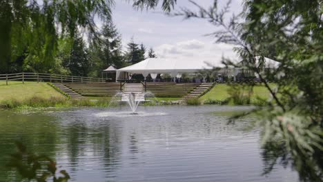 a big farm with a lake and a fountain