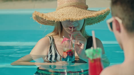 couple enjoying cocktails in a pool