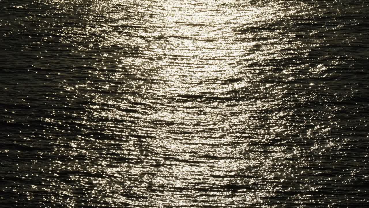 Glistening Sea Surface At Dusk In Cascais Resort Town Near Lisbon, Portugal. Tilt-up Shot