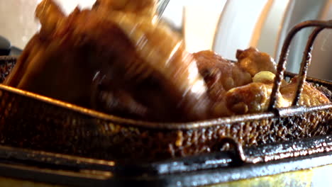 close up of cooked crispy chicken being boiled in hot pan with cooking oil